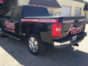Black work truck with red decals for landscaping company