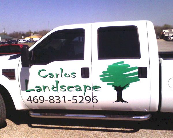 White work truck with vinyl decals for landscape company