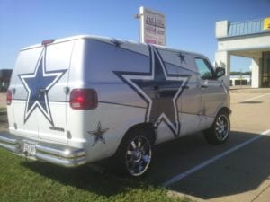 White and silver van with Dallas Cowboys logos