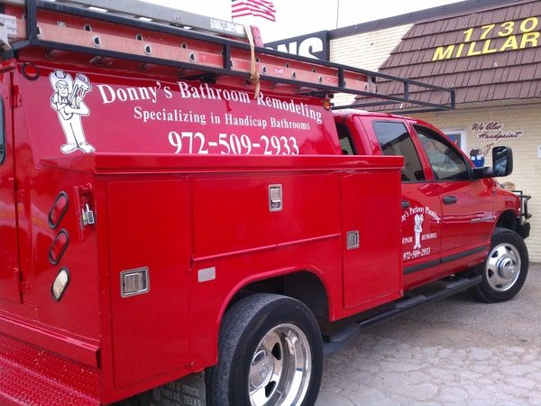 Red work truck with white decals for remodeling company