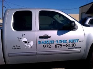 Silver truck with vinyl decals for pest control company