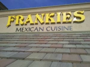 Yellow and black storefront sign for Frankies Mexican Cuisine