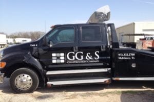 Black work truck with white vinyl decals for construction company