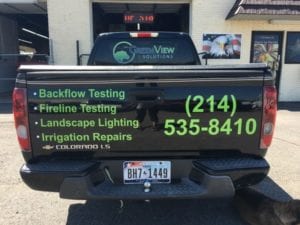 Black Chevy truck bed with green vinyl decals