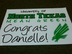 White banner with UNT logo that says Congrats Danielle