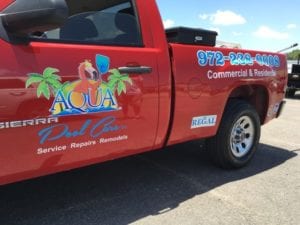 Red work truck with vinyl decals for pool repair company