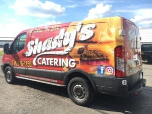 Work truck with vinyl wrap for catering restaurant