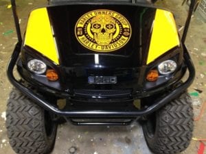 Black and yellow golf cart with Harley-Davidson Group skull decal