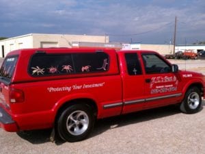 Red truck with decals for a pest control company