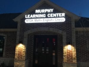 White storefront sign for Murphy Learning Center