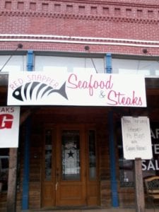 White banner for seafood and steak restaurant