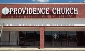 White storefront sign for Providence Church