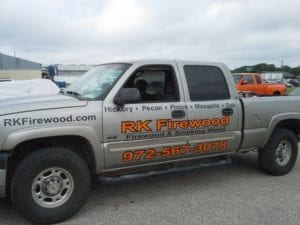 Grey truck with vinyl decals for a firewood and smoking wood company