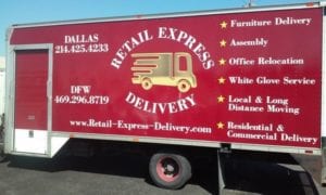 Large red enclosed trailer with vinyl decals for a delivery company