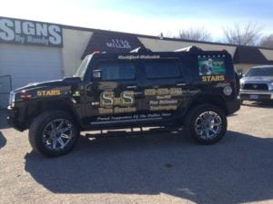 Large Hummer with vinyl decals for a tree services company