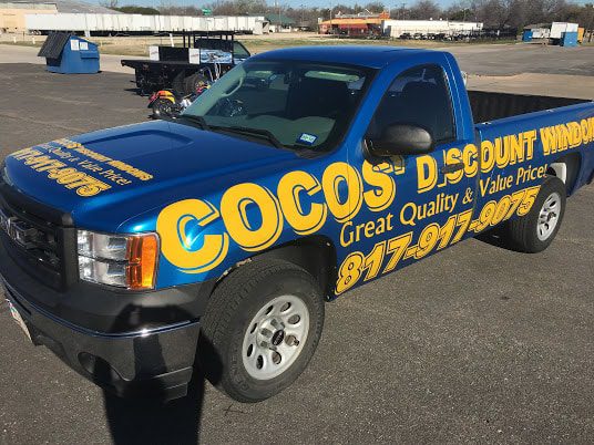Cocos Discount Window truck with bold yellow lettering car wrap