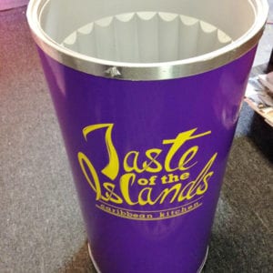 Tall beverage cooler with decals for Caribbean restaurant