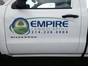 Door of white truck with logo decal for a landscaping company