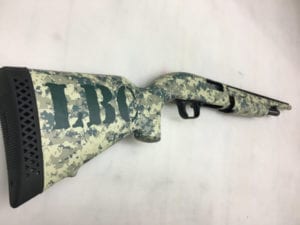Rifle with camouflage wrap and initials decal